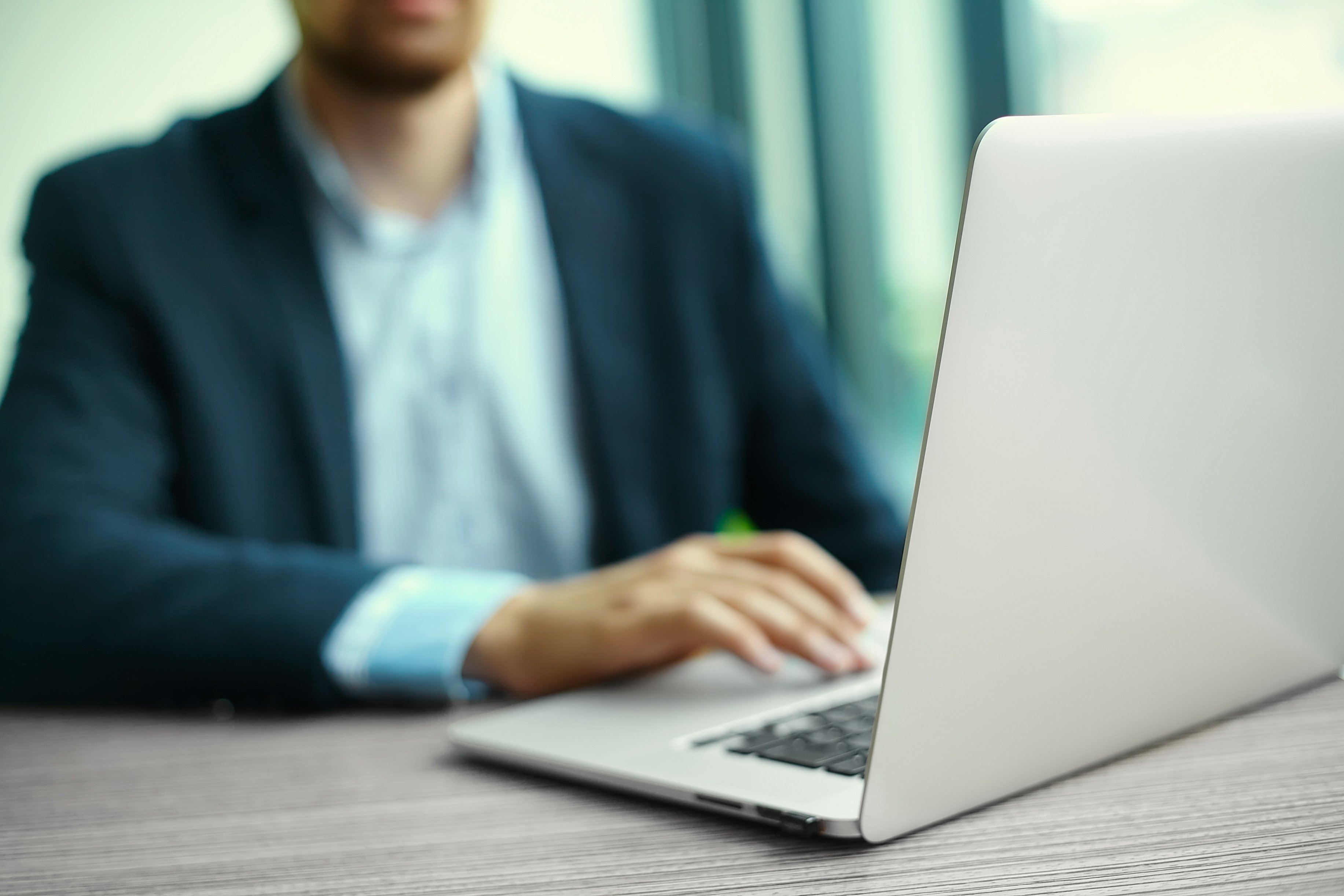 young-man-working-with-laptop-man-s-hands-notebook-computer-business-person-workplace-1